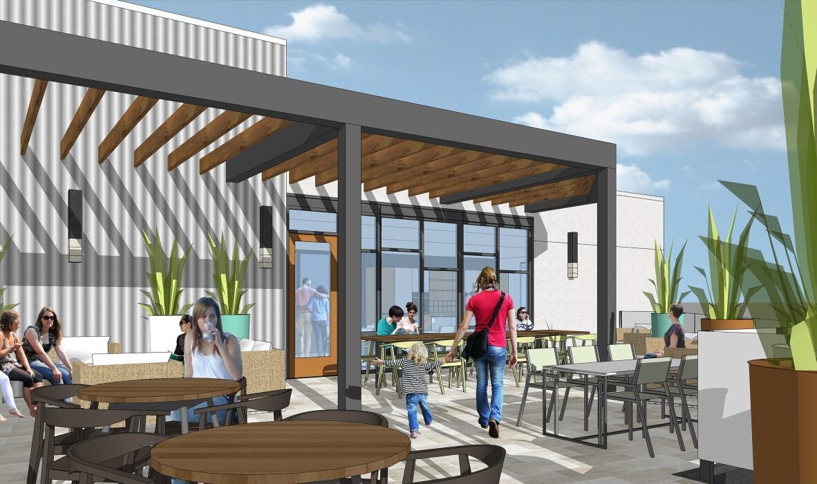 A lively outdoor patio features modern furniture, tables, and lush green plants. People sit and stand, engaging in conversations under a pergola with wooden beams. Tall planters line the space under a partly cloudy sky.