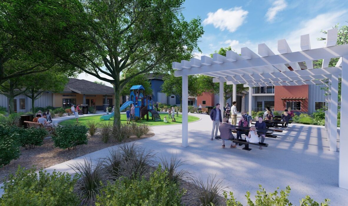A vibrant community park with a playground, benches, and lush greenery. People are enjoying the outdoors under a white pergola and near play structures. Buildings and trees provide additional shade and ambiance on a sunny day.