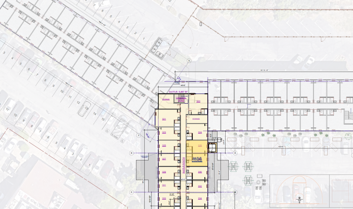 A detailed architectural site plan featuring a building layout with marked rooms and corridors in the center. Adjacent parking lots and a basketball court are visible. Some outdoor seating and landscaping elements are included in the design.