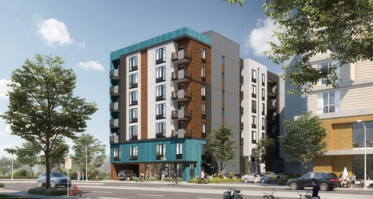 A modern multi-story apartment building with balconies and a mix of wood and teal accents, set on an urban street corner with trees, pedestrians, cyclists, and a car in the foreground. The sky is clear and sunny.