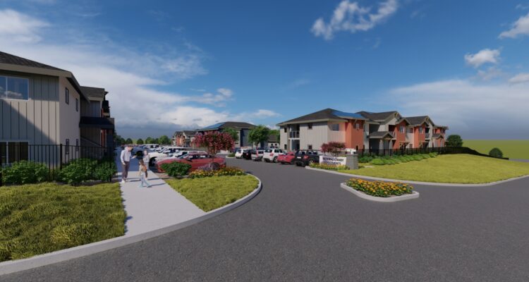 A suburban neighborhood with residential buildings and a large parking lot. People walk along a sidewalk lined with grass and flowers. A bright blue sky with scattered clouds completes the scene.