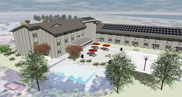 Birds-eye view of a modern building with solar panels on the roof. The surrounding area includes trees, outdoor seating with umbrellas, and a pool. The landscape is minimalistic with a clear sky backdrop.
