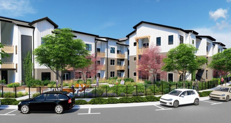 A modern apartment complex with three stories, featuring a white facade and black roofing. There are trees and landscaping in front, several cars parked on the street, and a clear blue sky above.